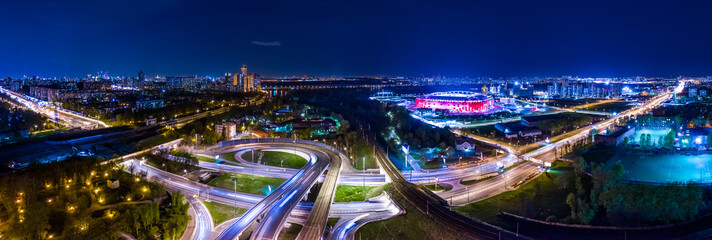 Night Aerial view panorama of a freeway intersection traffic trails in night Moscow