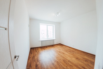 modern light interior. room with white walls and wooden floor. white open door.