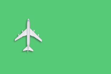flat lay traveling conceptual with airplane. Transportation concept. colorful background. Many white air plane on green background in left side, space for text.