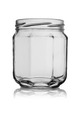 Empty glass jar of a six-sided form isolated on a white background with reflection