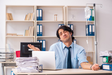 Young male employee in blood transfusion concept