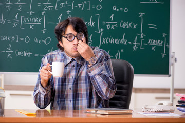 Funny male math teacher in the classroom 