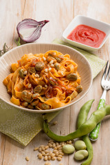 fettuccine pasta with broad bean tomato and pine nuts