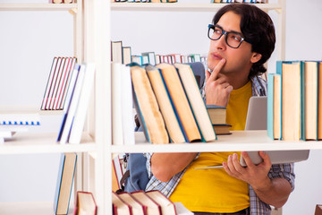 Male student preparing for exams at library 