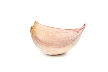 Single clove of garlic isolated on white background in close-up.