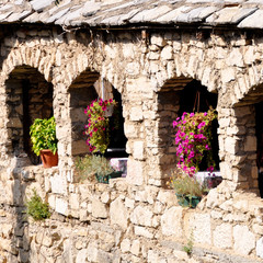 Fototapeta na wymiar old restaurant hanging flowers on the windows