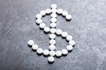 White Pills In The Shape Of A Dollar Sign