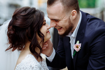 Caucasian happy groom and bride face to face in a second before kiss. Wedding celebration