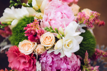 bouquet of flowers with roses, peonies, carnations. delicate bouquet in pink colors. eucalyptus leaves.