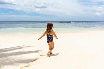 Fototapeta na wymiar Little Girl Walking On Anse Baleine Beach