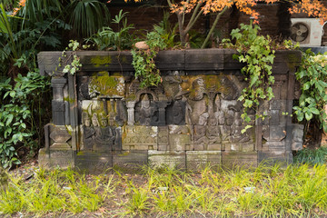 Ancient plate with relief symbols covered by moss in the jing'an park in China, Shanghai