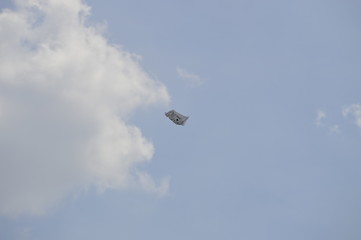 A motivational plastic bag flying in the wind against clouds