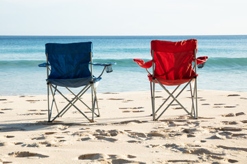 Blue And Red Chairs On Sandy Beach