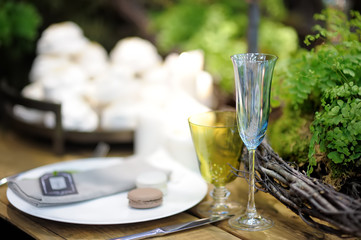 Table set for an event party or wedding reception in rustic or scandinavian style decorated moss and fern. Fashionable table set.