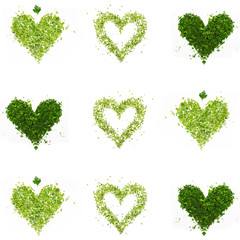 a green hearts of chopped parsley and dill on white background