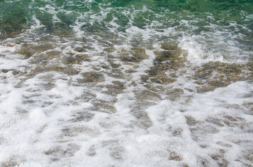 Abstract wave background, texture of white marine foam on beach