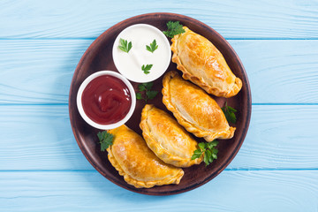 Latin American baked beef empanadas with sauce
