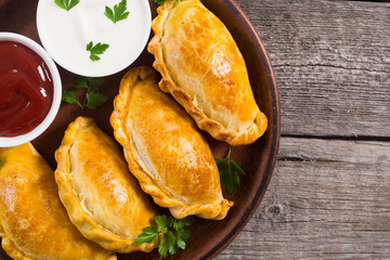 Latin American baked beef empanadas with sauce