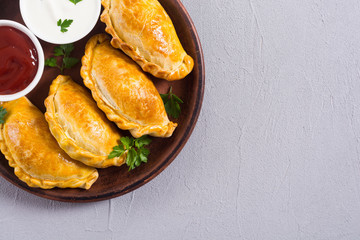 Latin American baked beef empanadas with sauce