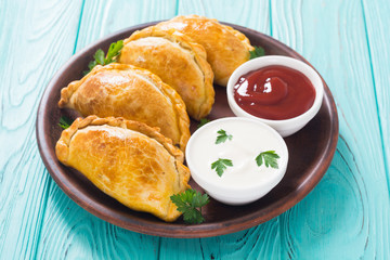 Latin American baked beef empanadas with sauce