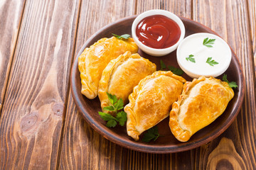 Latin American baked beef empanadas with sauce