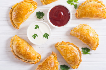 Latin American baked beef empanadas with sauce