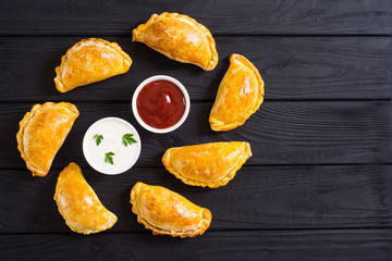 Latin American baked beef empanadas with sauce