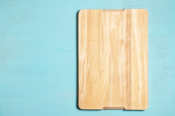 Cutting board on a blue wooden background.