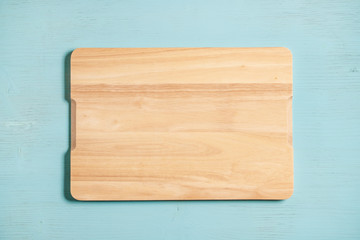 Cutting board on a blue wooden background.