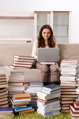 Young female student preparing for exams at home 