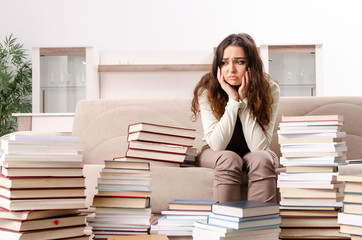 Young female student preparing for exams at home 