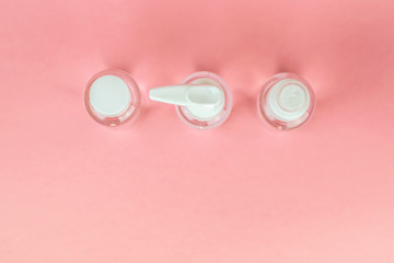 Beauty cosmetics glassbottle; branding mock up; Top view on pastel pink background. Package for essential oil.