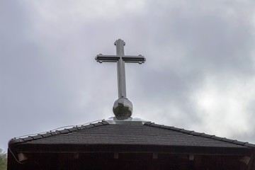 Church Roof with a cross. Church building roof with holy cross - 269769519