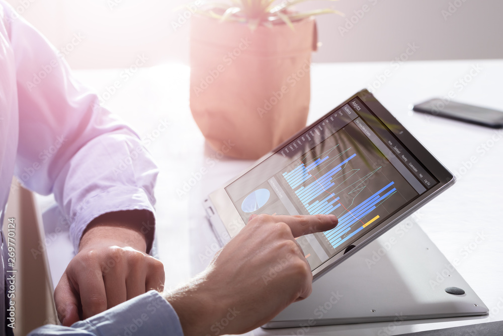 Poster businessman using graph on laptop