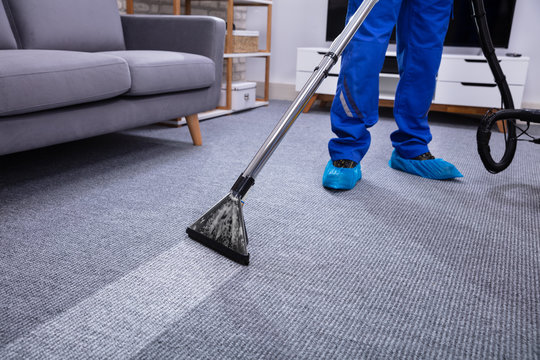 Male Janitor Cleaning Carpet - Powered by Adobe