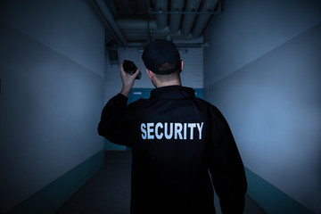 Male Security Guard Standing In Corridor