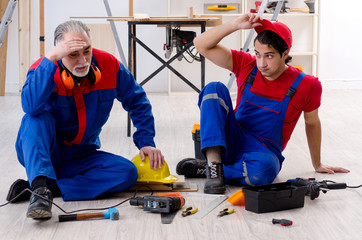 Fototapeta premium Two professional contractors laying flooring at home 