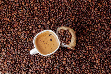 Coffee cup with coffee bag on wooden table. View from top