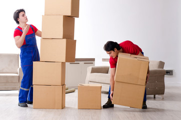 Two young contractor employees moving personal belongings