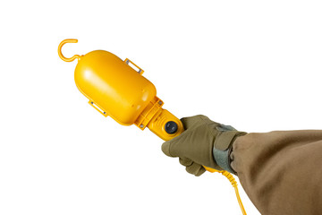 Arm holding yellow portable lamp.