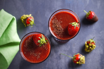 Strawberry smoothie with berry and chocolate. Healthy drink   on gray background