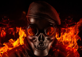 Soldier in skull mask, glasses and beret face front view closeup.