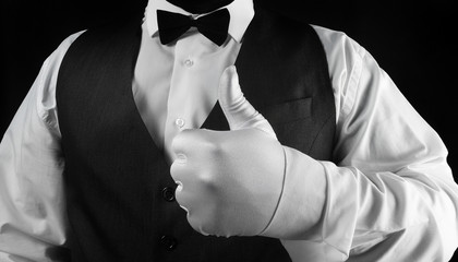 Waiter showing thumbs up in white glove.