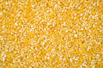 raw crushed corn groats close up