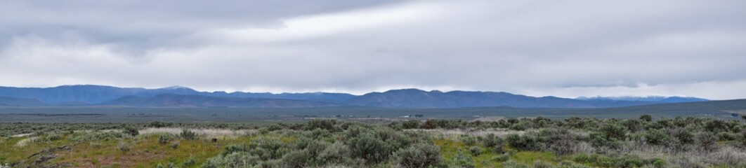 Naklejka premium Sawtooth Mountains National Forest Landscape stormy panorama from South headed to Sun Valley, view of rural grazing land, Sagebrush, Lava Fields in Idaho. United States.