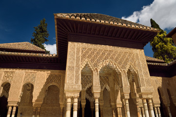 Fototapeta na wymiar Ornately decorated stiled arches in the courtyard of the Lions at Nasrid Palaces Alhambra Granada
