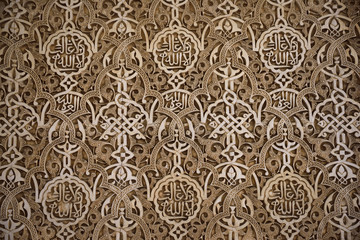 Fototapeta premium Detail of arabesque wall designs at the courtyard of the Lions of Nasrid Palaces Alhambra Granada