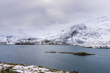 Landscape of snowy mountains and cloudy sky in Norway in summer