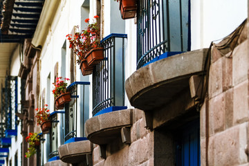 Blue balconies with plants and flowers in a colonial building in Cusco, Peru
