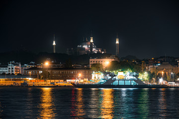 Fototapeta na wymiar Fantastic view of the city silhouette and mosque with light reflection at the Bosphorus, Istanbul.